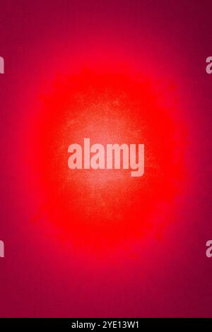 Red textured background with glowing center Stock Photo