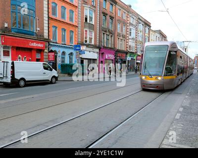 Dublin, Ireland's Lua light rail system tram on the Red Line on Middle Abbey Street approaching O'Connell Street; city public transportation. Stock Photo