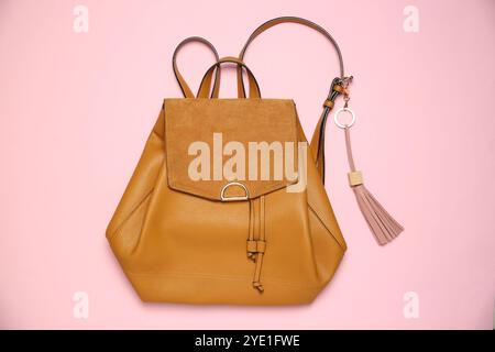 Backpack with leather keychain on pink background, top view Stock Photo