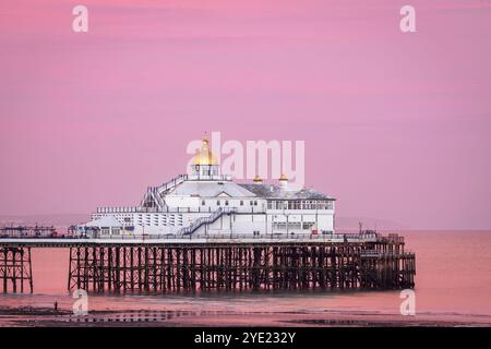 Lilac skies over Eastbourne Pier at low tide and sunset east Sussex south east England UK Stock Photo