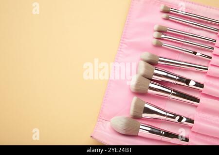 Makeup brushes in beige cosmetic bag. Top view Stock Photo