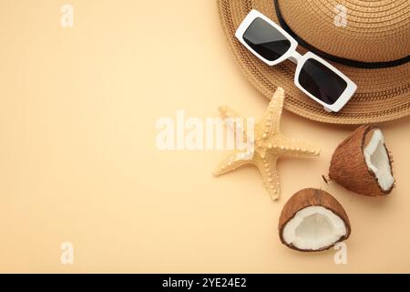 Summer accessories with coconuts on beige background. Space for text Stock Photo