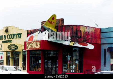 Kamikaze clothing store in the city of Auckland, New Zealand, with a mock-up of a Japanese Kamikaze Second World War plane crashed into it. Unusual shop attraction in 1996. The display and shop is no longer in place Stock Photo