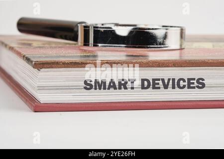 The concept of technology and development. Phrase, words, text SMART DEVICES on the end of the book, a close-up front view. Stock Photo