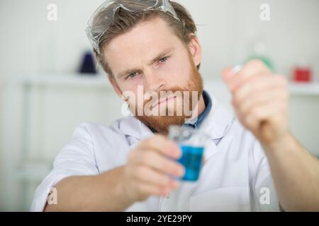 man checking liquids in the lab Stock Photo