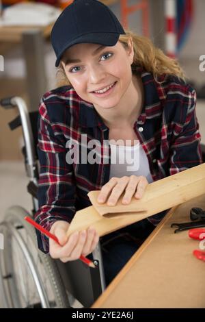 disable female carpenter using a saw Stock Photo