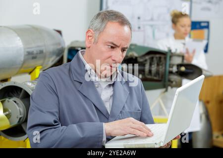 mature engineer with laptop in hands Stock Photo