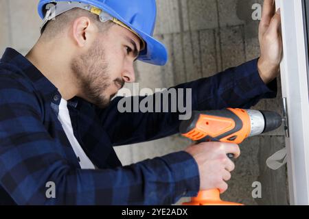 male builder using cordless drill Stock Photo