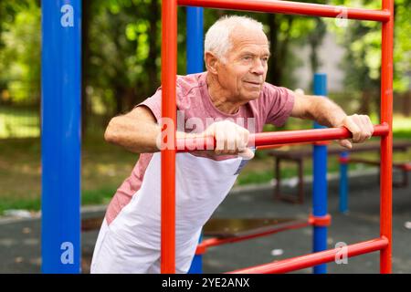 Senior european man doing push-ups outdoors Stock Photo