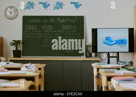 Empty classroom featuring blackboard with 3D modeling steps and digital illustration on screen creating visually educational environment for students Stock Photo