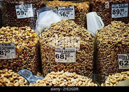 Container, nuts and market with price label in store for grocery shopping, healthy snack or diet in aisle. Merchandise, selection or range of stock Stock Photo