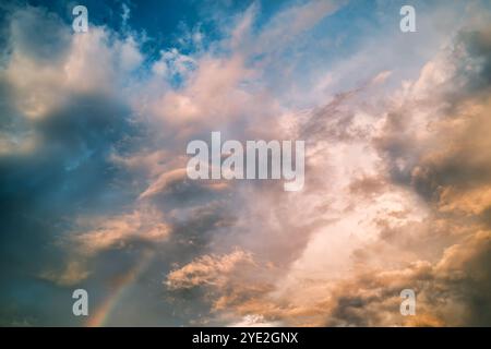 Dramatic colorful sky with cloud and rainbow in the sunset Stock Photo