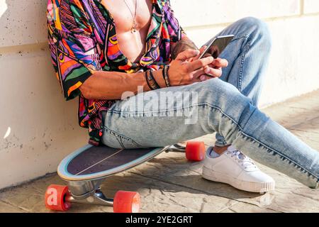 unrecognizable hipster chatting on mobile phone Stock Photo
