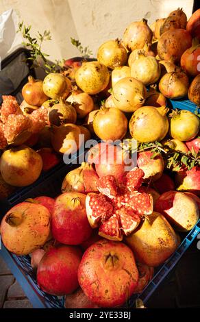Pomegranates showing the internal asymmetrical chambers of seeds and flesh at market stall in Foca Turkey Stock Photo