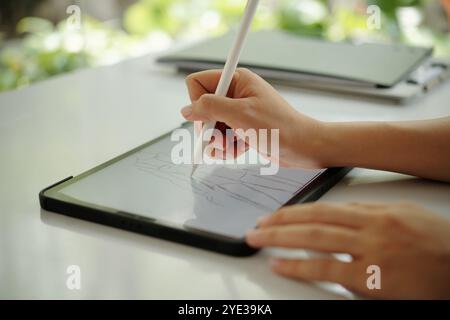 Using Digital Pen for Artistic Design on Tablet Stock Photo