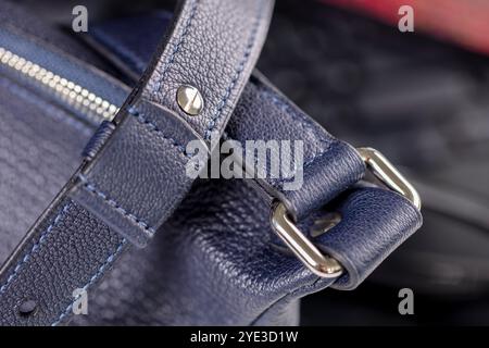 Part of a blue leather bag on a black background. Leather goods. Stock Photo