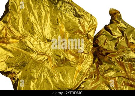 Texture of crumpled gold foil paper on a white background. Stock Photo