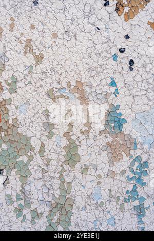 An old wall background with a blue and white peeling paint. Pastel colored creative background. Stock Photo