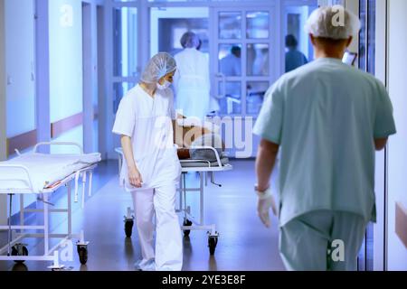 The corridor of the hospital. The weekdays of an outpatient clinic or intensive care unit with a gurney for patients and doctors. Stock Photo