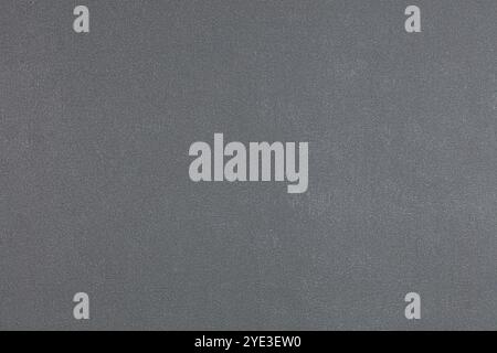 Background of gray evenly textured paper wallpaper. Gray plastered wall. Stock Photo