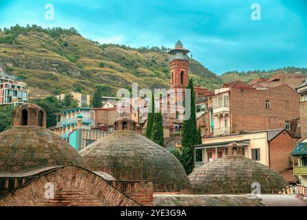 Scenic shape domes of ancient hot spring bathhouse. Abanotubani district known for its sulfuric baths.Tbilisi ancient district.Georgia. Stock Photo