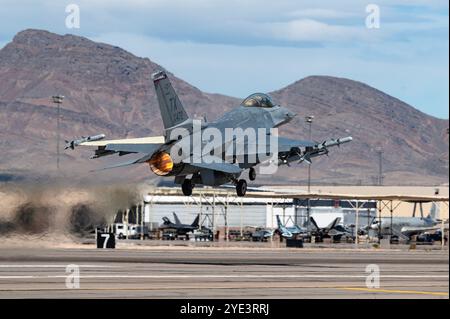 An F-16 Aggressor assigned to the 706th Aggressor Squadron takes off for a Red Flag-Nellis 24-2 mission at Nellis AFB, Nevada, March 14, 2024. During Stock Photo