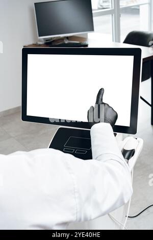 A person in gloves interacting with a touchscreen display in a modern office environment Stock Photo