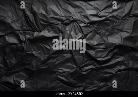 Black paper sheet texture cardboard background.Crumpled black paper texture background. Stock Photo
