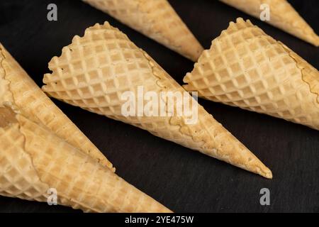 waffle cones for ice cream on a black slate , several waffle cones for ice cream Stock Photo
