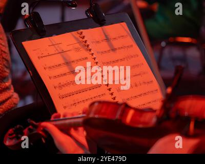 Sheet music on the music stand. Violinist playing beforehead Stock Photo
