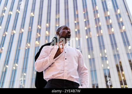portrait of an African-American businessman carrying an American over his shoulder Stock Photo