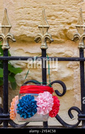 Colorful Decorated Glass Jar Hanging on Decorative Fence Stock Photo
