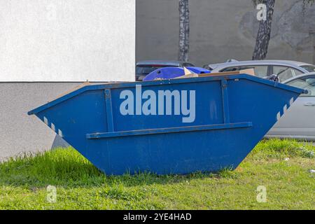 Blue Skip Waste Open Top Metal Container at Green Grass Stock Photo - Alamy