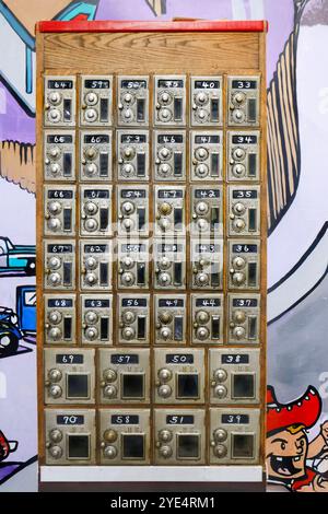 Vintage metal safety deposit boxes with number dials on a colorful graffiti wall background in a retro setting Stock Photo