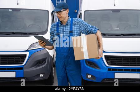 Delivery man in uniform with digital tablet.. Stock Photo