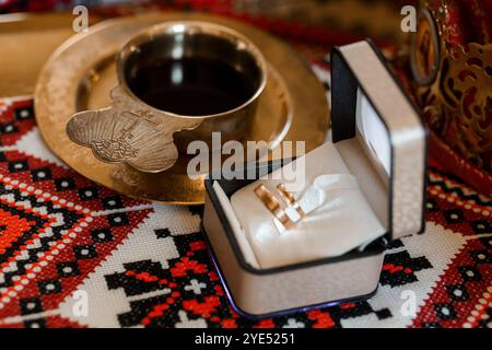 Elegant Wedding Rings in a Decorative Box on Traditional Textile Background. Stock Photo