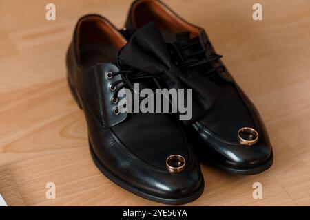 Elegant Men's Dress Shoes with Bowtie and Wedding Rings. Stock Photo