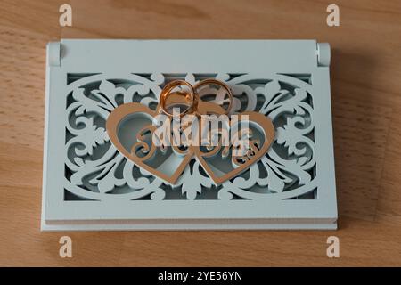 Elegant Wedding Rings on Decorative Heart-Shaped Stand. Stock Photo