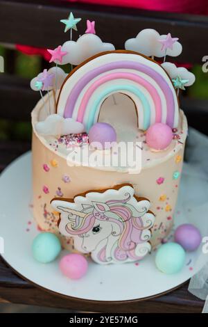 Unicorn Themed Birthday Cake with Rainbow and Decorative Elements. Stock Photo