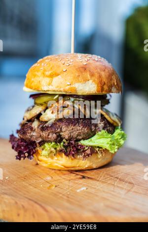 beef burger with vegetables on a wooden board Stock Photo