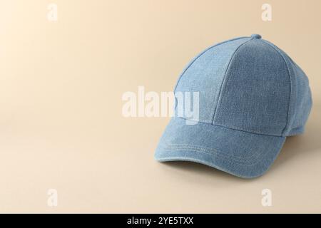 Stylish denim baseball cap on beige background. Mockup for design Stock Photo