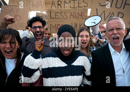 Young Muslim woman with crowd of diverse people protesting against war and violence in world Stock Photo