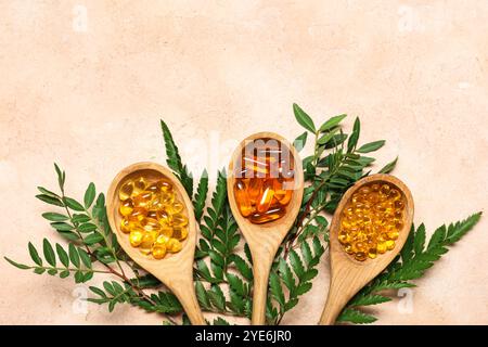 Composition with wooden spoons of different pills and plants on color background Stock Photo