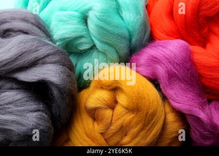 Different colorful wool for felting as background, closeup Stock Photo