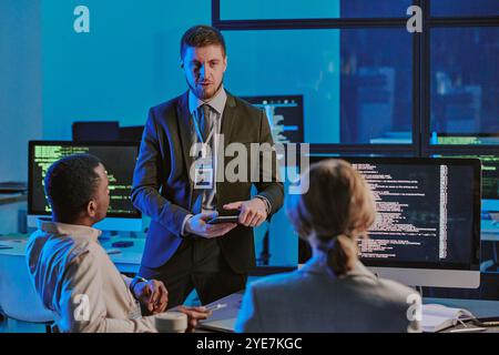 Young Man Speaking During Meeting In Cybersecurity Office Stock Photo