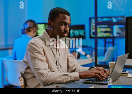 Ethical Hacker Working On Laptop In Office Stock Photo