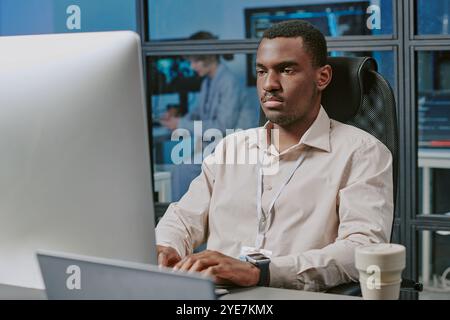 Serious Black Man Typing On Computer Stock Photo