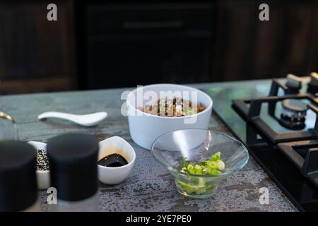 Preparing delicious dish with fresh ingredients in modern kitchen, at home Stock Photo