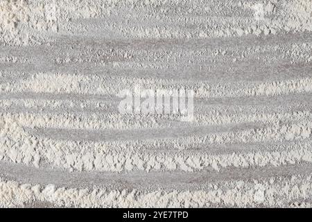 Grey cooking background of spilled wheat flour on stone background, top view. Stock Photo