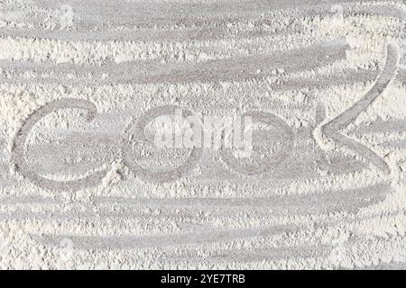 Grey cooking background of spilled wheat flour on stone background with text cook Stock Photo